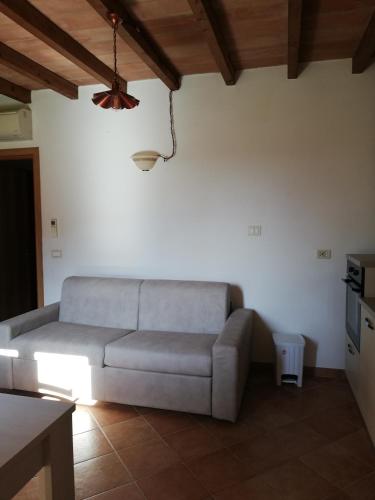 a living room with a couch and a table at Agriturismo da Remo in Magliano in Toscana