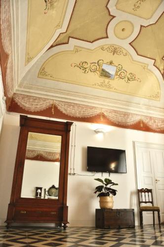 a room with a ceiling with a mirror and a chair at Casa Turi in Alberobello