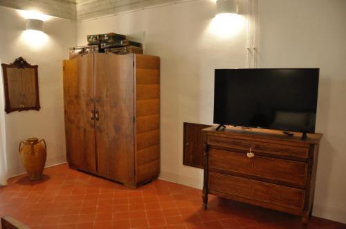 a television on a wooden dresser in a room at Casa Turi in Alberobello