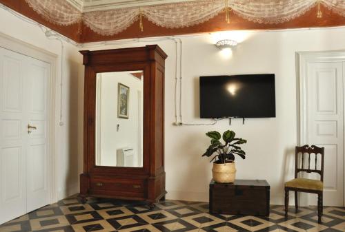 a room with a mirror and a tv on a wall at Casa Turi in Alberobello