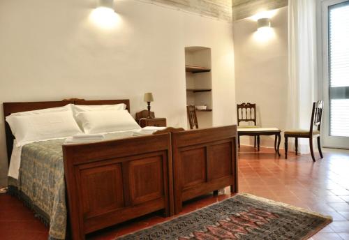 a bedroom with a bed and a table and a chair at Casa Turi in Alberobello