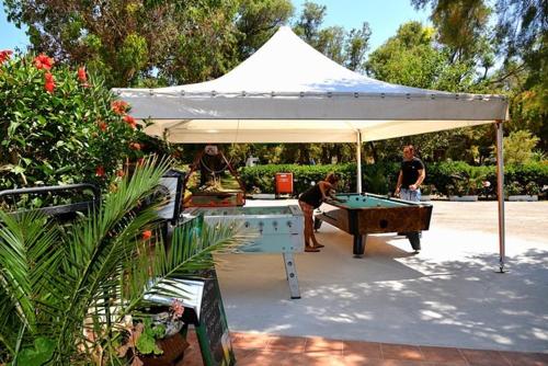 a white tent with a pool table under it at Camping Mithimna in Kissamos