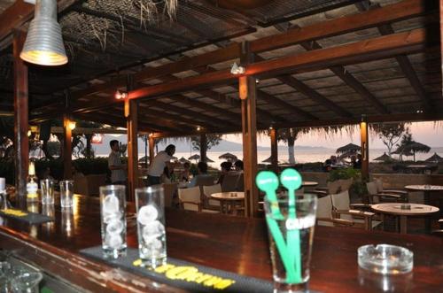 a bar in a restaurant with a table and chairs at Camping Mithimna in Kissamos
