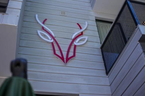 a sign on the side of a house with antlers at Borjomi UnderWood in Borjomi