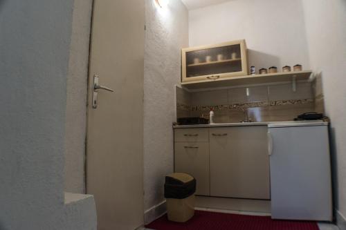 a small kitchen with a sink and a microwave at Maja Apartments in Ohrid