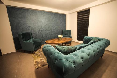 a living room with a couch and a table and chairs at Borjomi UnderWood in Borjomi