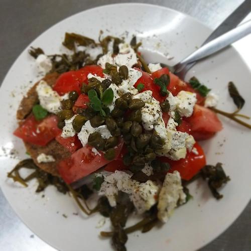 a white plate of food with tomatoes and cheese at Ble Mavi - Studio for 2 in Vouni