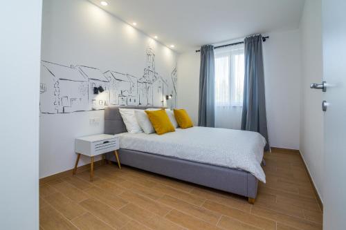 Postel nebo postele na pokoji v ubytování FK Apartments
