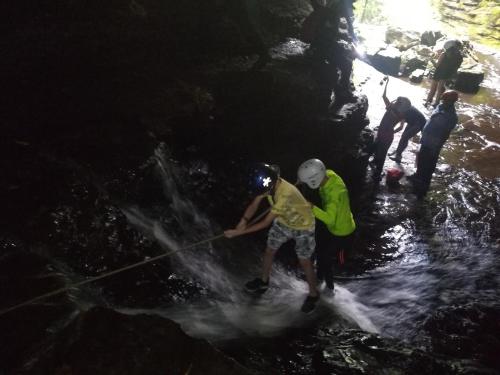 a group of people standing in the water in a cave at Hotel El Ganadero in El Total
