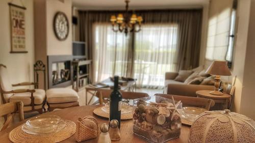 a living room with a table and a living room with a couch at Estia, Cozy & Stylish Villa - Elani in Siviri