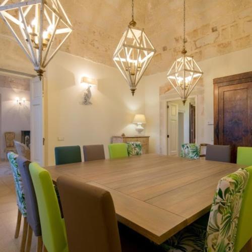 a dining room with a large wooden table and chairs at Villa Pardonise- Puglia-Salento-Casa vacanze in Diso