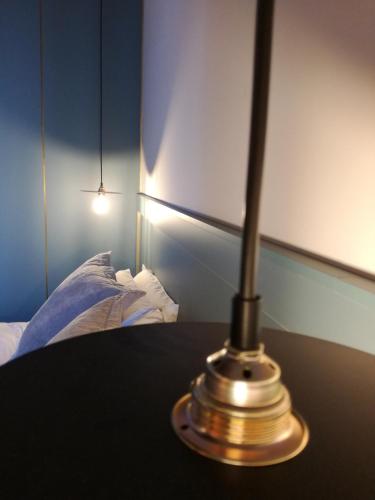 a lamp sitting on a table next to a bed at Old Town SXVI - Adults Only in Telde