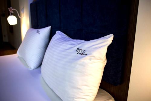two pillows sitting on top of a bed at Fly inn Hotel Lounge in Machelen