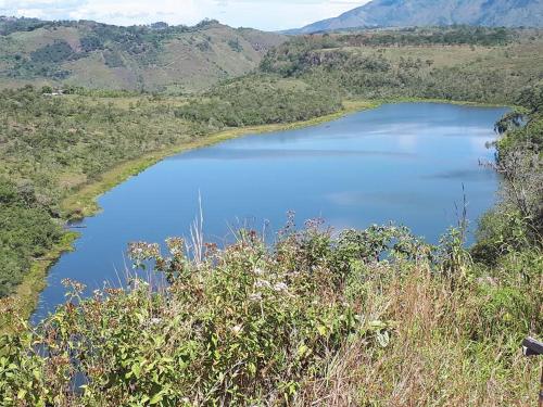 a view of a lake in the middle of a valley at Ecohotel Bordones in Isnos