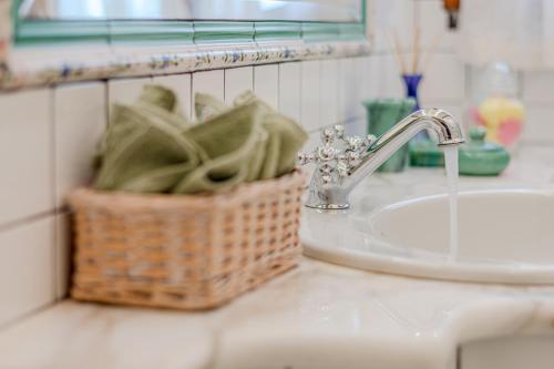 a basket sitting on a bathroom counter next to a sink at Casa Bici in Chianni