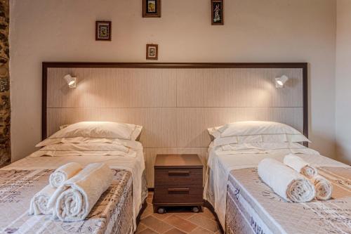 a bedroom with two beds with towels on them at Casa Bici in Chianni