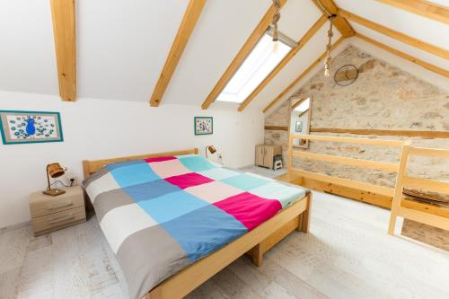 a bedroom with a bed in a room with beams at Pelagia House in Zlarin