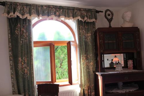 a window in a room with a table and a mirror at Penzion St. Florian Příbor in Příbor