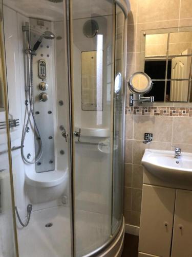 a bathroom with a shower and a sink at Southfield lodge in Middlesbrough