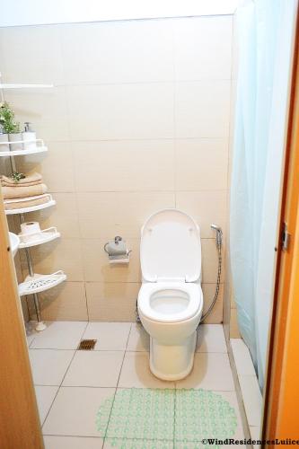 a bathroom with a white toilet in a stall at Wind Residences For Rent - Luiice in Tagaytay