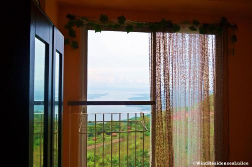a window with a view of a field at Wind Residences For Rent - Luiice in Tagaytay