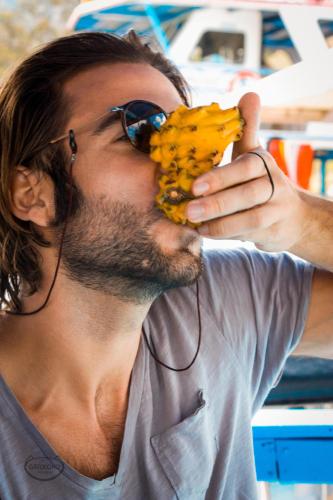 a man wearing sunglasses eating a bunch of bananas at Casa Encuentro Ecolodge, Outdoor Gym and Yoga in Guatapé
