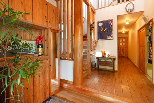 a hallway of a house with wooden floors and a clock at AbbeyRoad Inn Seika in Seika