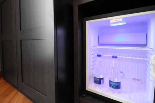 an open refrigerator with drinks in it in a room at Piazza Carità in Naples