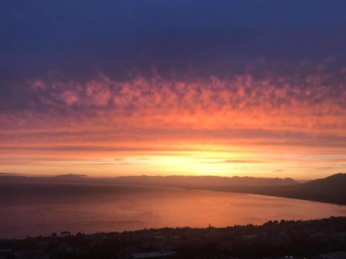a sunset over a body of water at Belvedere Hotel in Kalamata