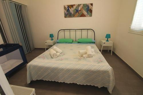 a bedroom with a bed with two stuffed animals on it at Casa Bluet in Lido Marini