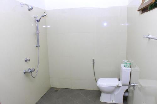 a bathroom with a toilet and a shower at Thal Sewana in Sigiriya