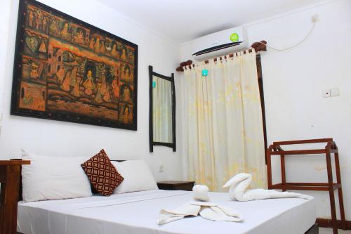 a bedroom with a bed and a painting on the wall at Thal Sewana in Sigiriya