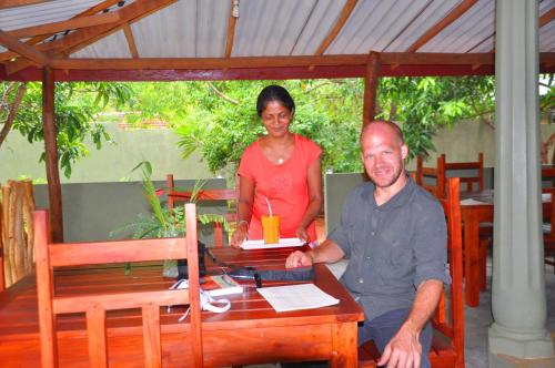 a man and a woman sitting at a table at Thal Sewana in Sigiriya