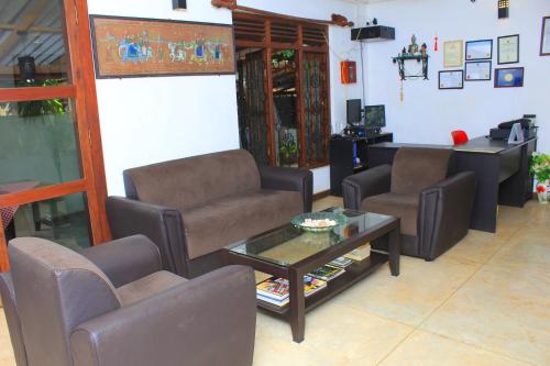 a waiting room with chairs and a coffee table at Thal Sewana in Sigiriya