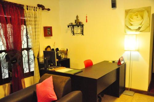 a living room with a desk and a couch at Thal Sewana in Sigiriya