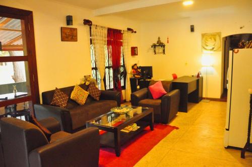 a living room with couches and a table at Thal Sewana in Sigiriya