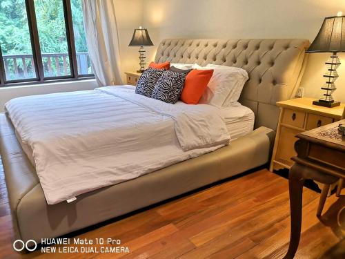 a bed with pillows on it in a bedroom at Kairos Villa in Seremban