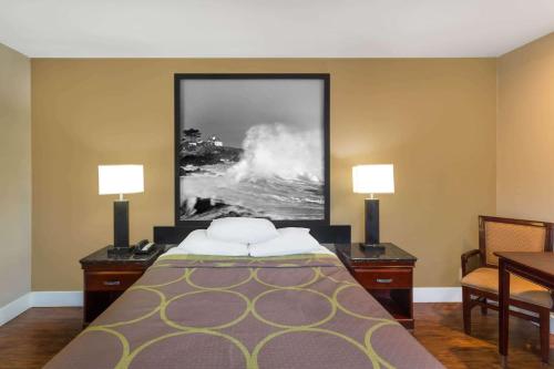 a hotel room with a bed and two lamps at Super 8 by Wyndham Martinez in Martinez