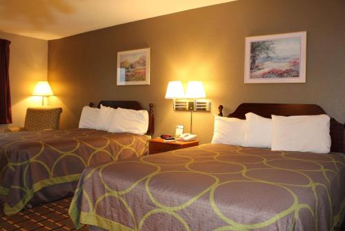 a hotel room with two beds and two lamps at Super 8 by Wyndham Valparaiso in Valparaiso