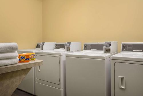 a row of washers and dryers in a laundry room at Ramada Golden in Golden