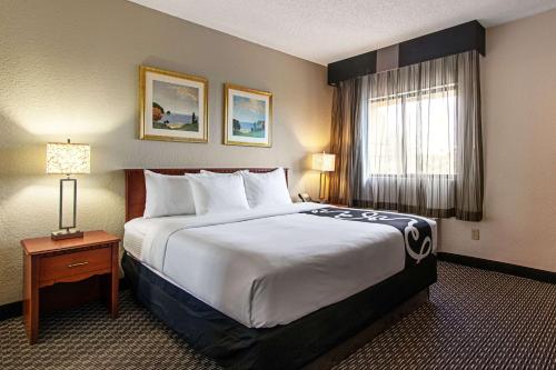 a hotel room with a large bed and a window at La Quinta Inn by Wyndham Ft. Lauderdale Tamarac East in Fort Lauderdale