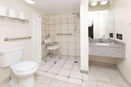 a bathroom with a toilet and a shower and a sink at Super 8 by Wyndham Ft Stockton in Fort Stockton
