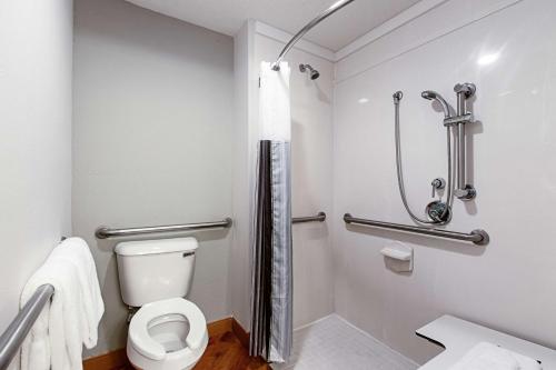 a bathroom with a toilet and a shower at La Quinta Inn by Wyndham Ft. Lauderdale Tamarac East in Fort Lauderdale