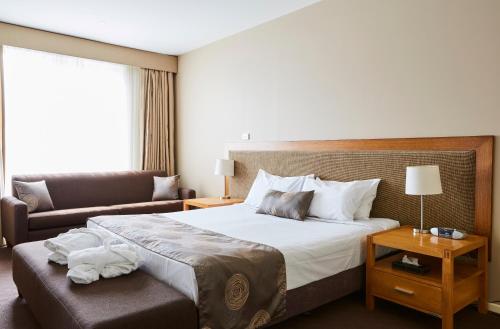 a hotel room with a bed and a couch at Mornington Hotel in Mornington