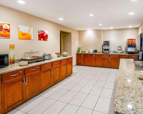 a large kitchen with wooden cabinets and appliances at Quality Inn Oakwood in Spokane