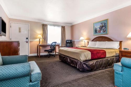 a hotel room with a bed and a desk at Econo Lodge Castro Valley I-580 in Castro Valley