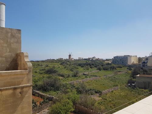 a view of a field from a building at Il Bejta penthouse in Qala