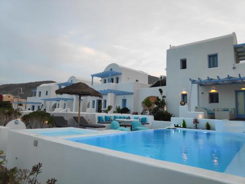a swimming pool with chairs and a villa at Santoxenia luxury villa in Kamari