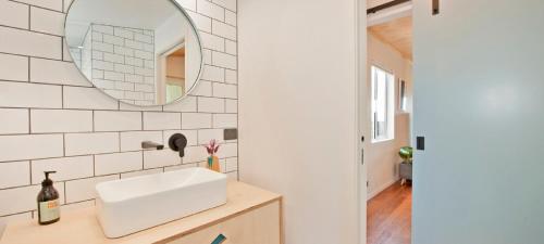 a bathroom with a sink and a mirror at Nelson City Escape in Nelson