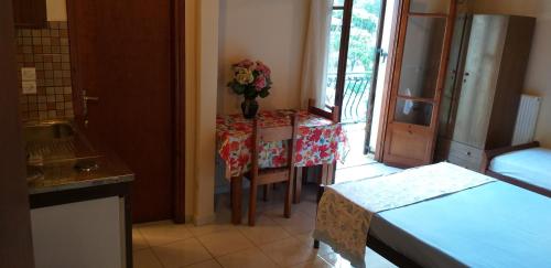 a kitchen with a table with a vase of flowers on it at Toulatos Pantelis in Pouláta